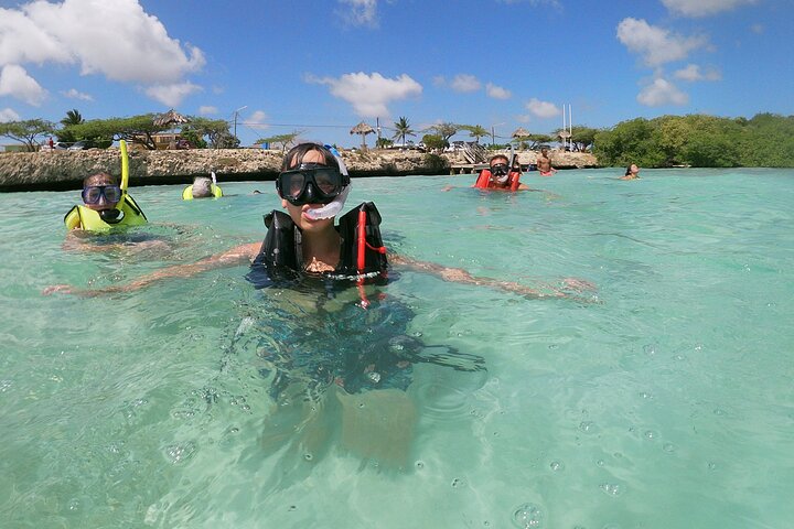 Group of snorkelers floating in clear Caribbean water at Mangel Halto Reef