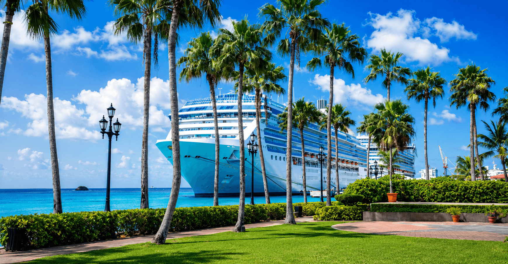 Large cruise ship docked beside palm trees and turquoise water in Oranjestad, Aruba.