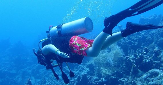 Scuba diver gliding over reef during Aruba dive tour